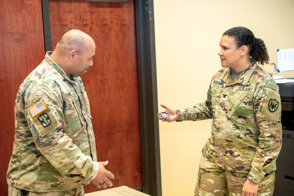 Sgt. 1st Class Holmes Receives Coin From Col. McGonegal