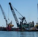 A Key Bridge Response crane operator removes wreckage