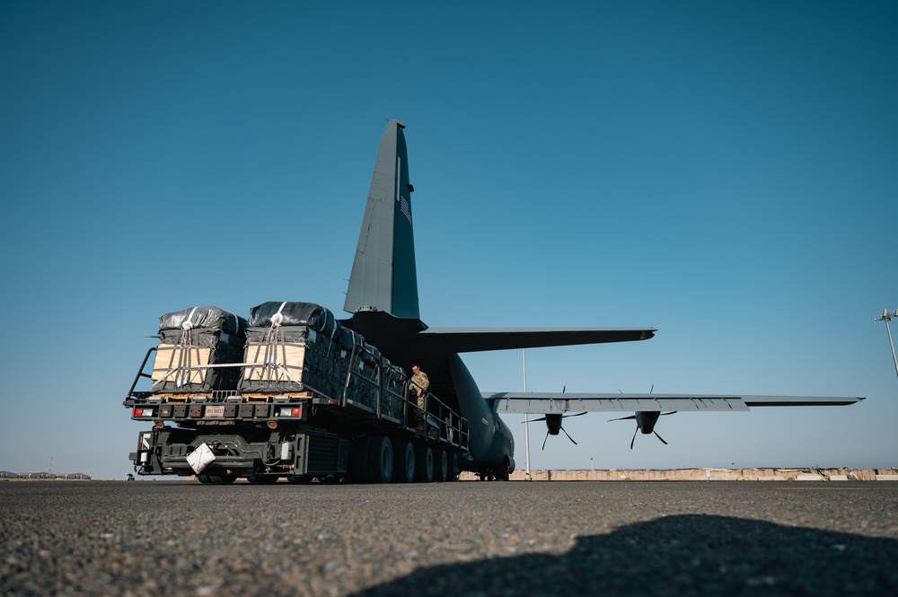 Airmen load AFCENT C-130 with humanitarian aid bound for Gaza