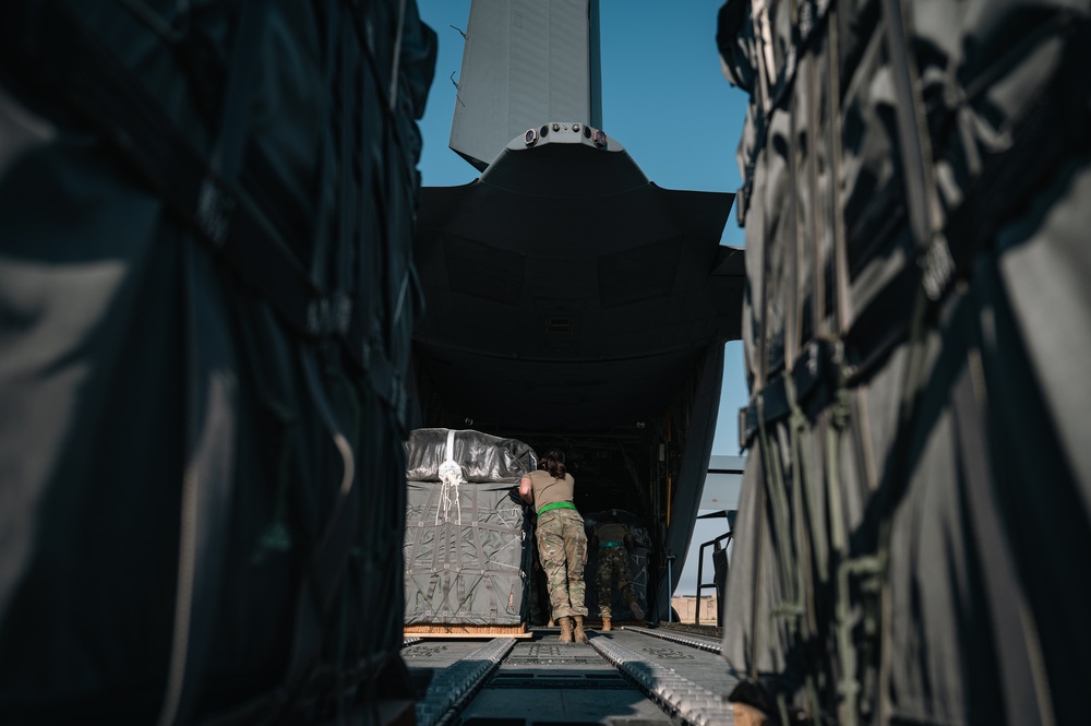Airmen load AFCENT C-130 with humanitarian aid bound for Gaza