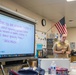 Lt. Cmdr. Lawrenz speaks with JROTC students at John F. Kennedy High School