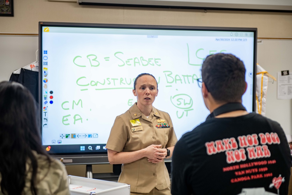 Lt. Cmdr. Lawrenz listens to a question from JROTC students at John F. Kennedy High School