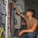 Sailors aboard the USS Howard apply primer to the ship's bulkhead in the South China Sea