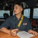 Sailors aboard the USS Howard stand watch in the pilothouse in the South China Sea