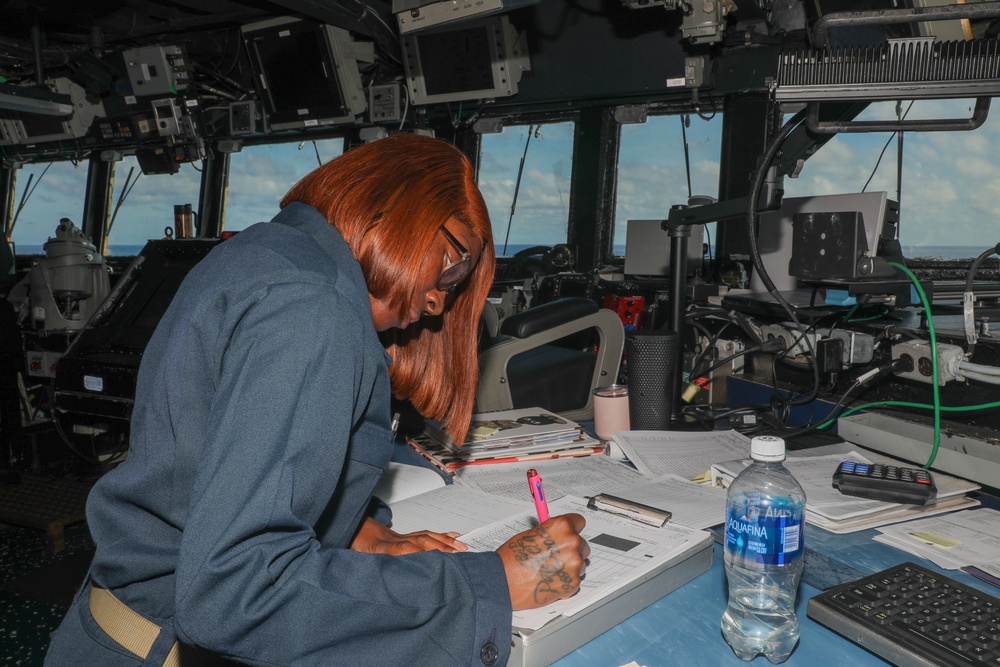 Sailors aboard the USS Howard stand watch in the pilothouse in the South China Sea