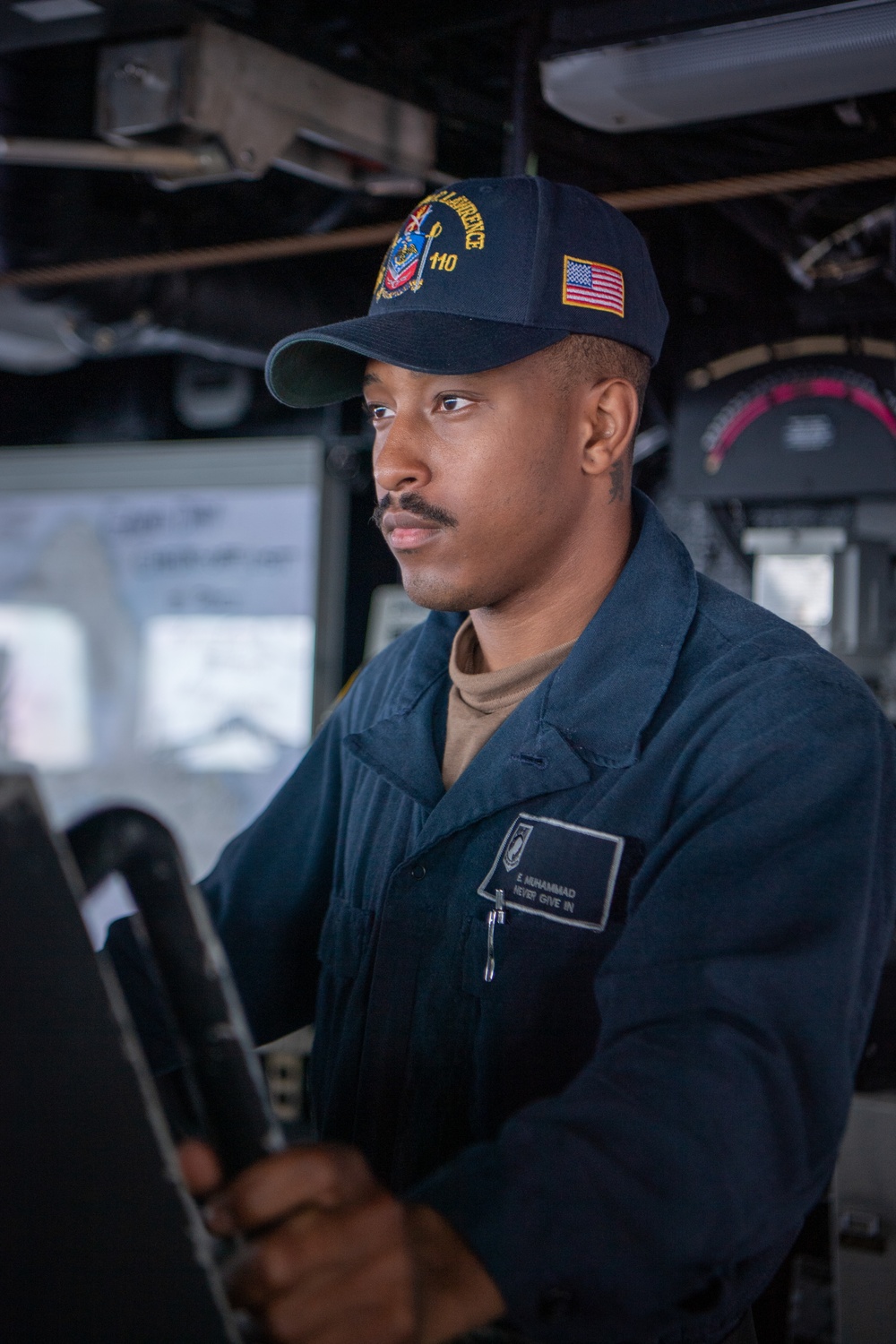 Sailor Stands Helmsman Watch Aboard USS William P. Lawrence