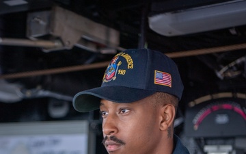 Sailor Stands Helmsman Watch Aboard USS William P. Lawrence