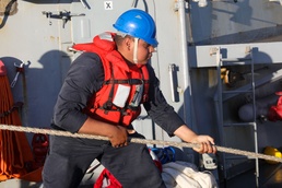 Sailors aboard the USS Howard conduct a replenishment-at-sea with the USNS John Ericsson in the South China Sea