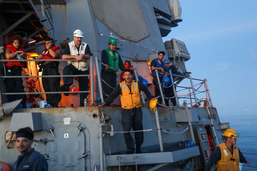 Sailors aboard the USS Howard conduct a replenishment-at-sea with USNS John Ericsson in the South China Sea