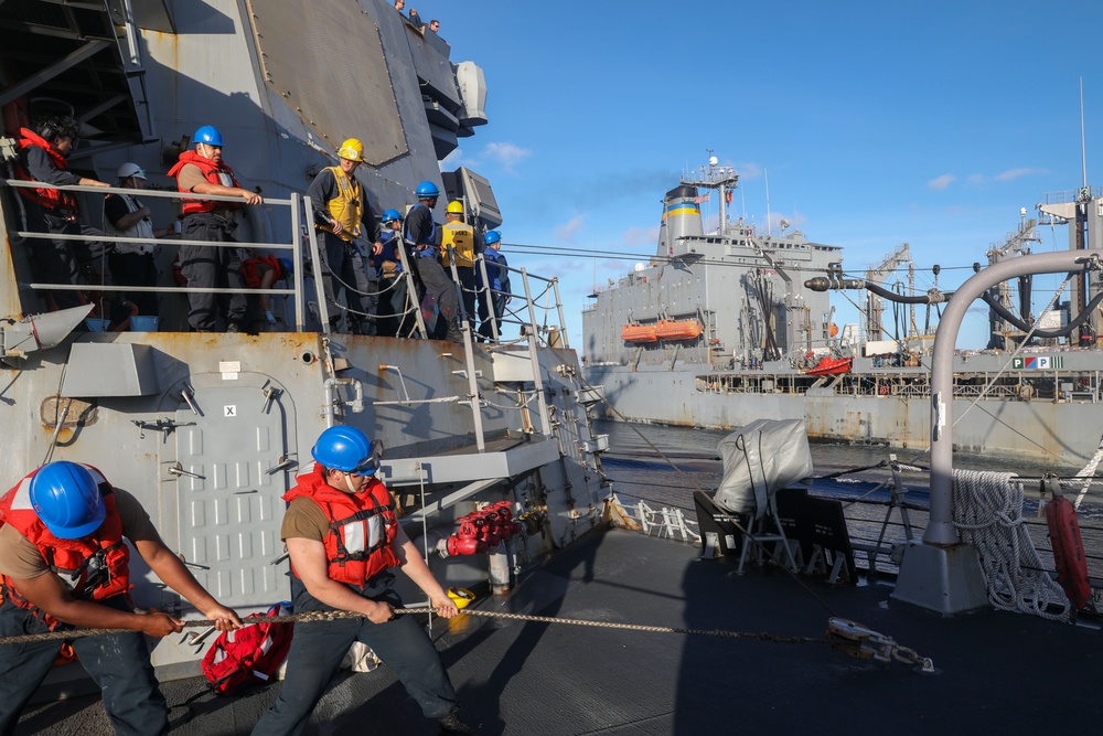 Sailors aboard the USS Howard conduct a replenishment-at-sea with the USNS John Ericsson in the South China Sea