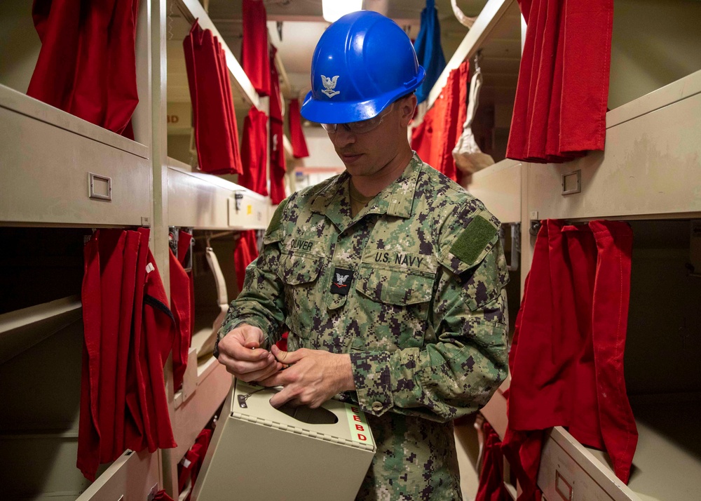 USS Makin Island Sailors Replace EEBD Rack Housings