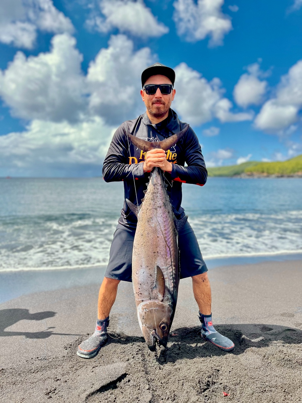 U.S. Coast Guard member conduct a fish call on Pagan