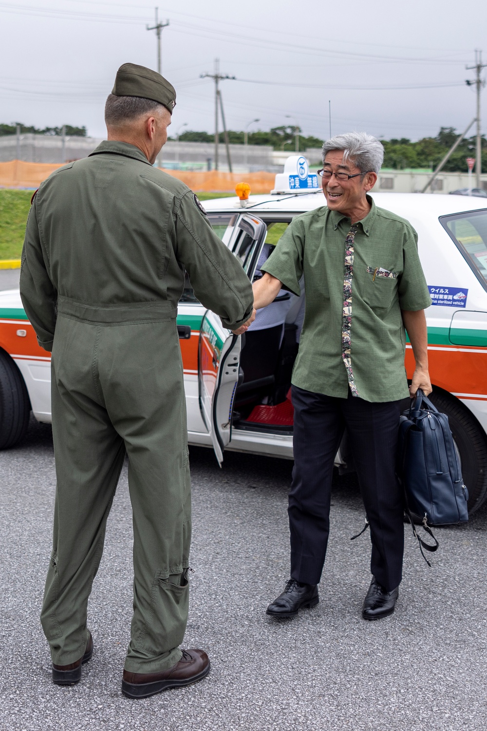 Members of the Ministry of Foreign Affairs of Japan tour MV-22B Osprey aircraft, simulator