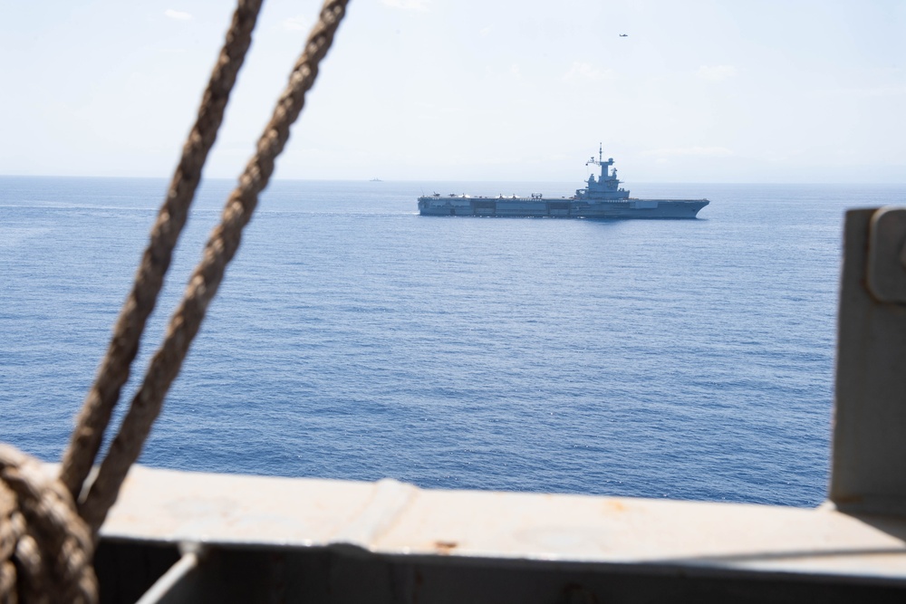 FS Charles De Gaulle (R91) passes alongside the Nimitz-class aircraft carrier USS Dwight D. Eisenhower (CVN 69) in the Mediterranean Sea