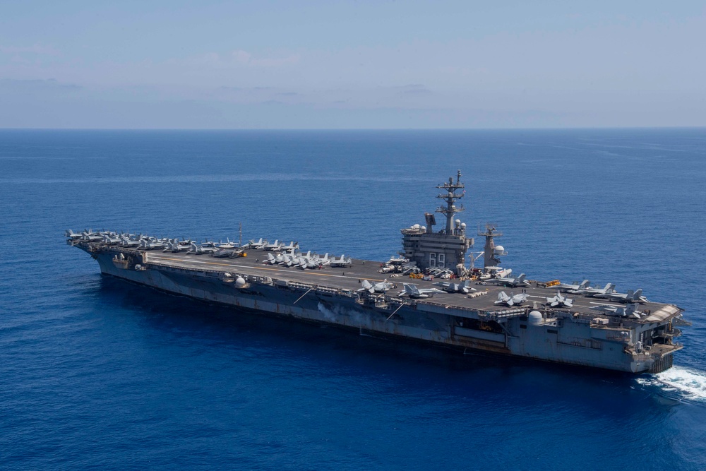 FS Charles De Gaulle (R91) passes alongside the Nimitz-class aircraft carrier USS Dwight D. Eisenhower (CVN 69) in the Mediterranean Sea