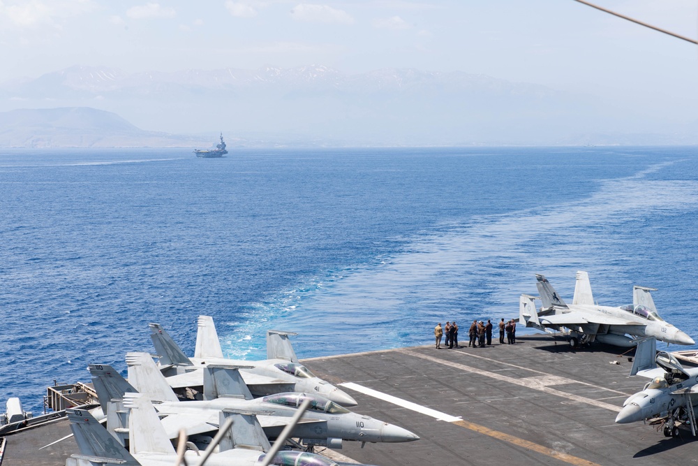 FS Charles De Gaulle (R91) passes alongside the Nimitz-class aircraft carrier USS Dwight D. Eisenhower (CVN 69) in the Mediterranean Sea