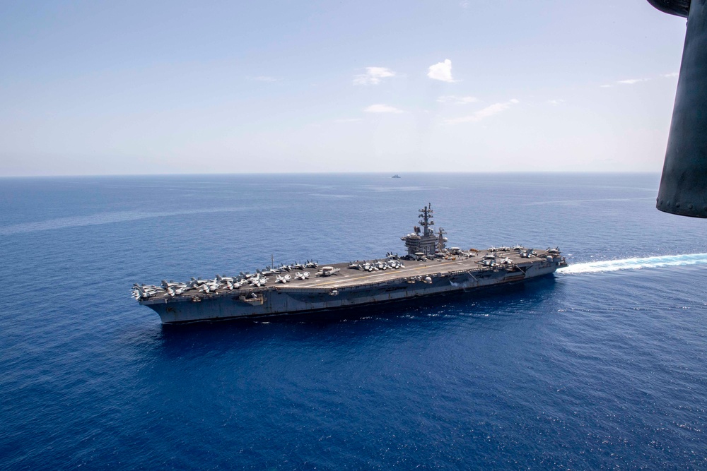 FS Charles De Gaulle (R91) passes alongside the Nimitz-class aircraft carrier USS Dwight D. Eisenhower (CVN 69) in the Mediterranean Sea