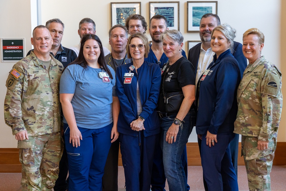 Brig. Gen. Christopher W. Cook and Command Sgt. Maj. Jodi Renner took a group photo with the leadership and staff of Columbus Regional Health