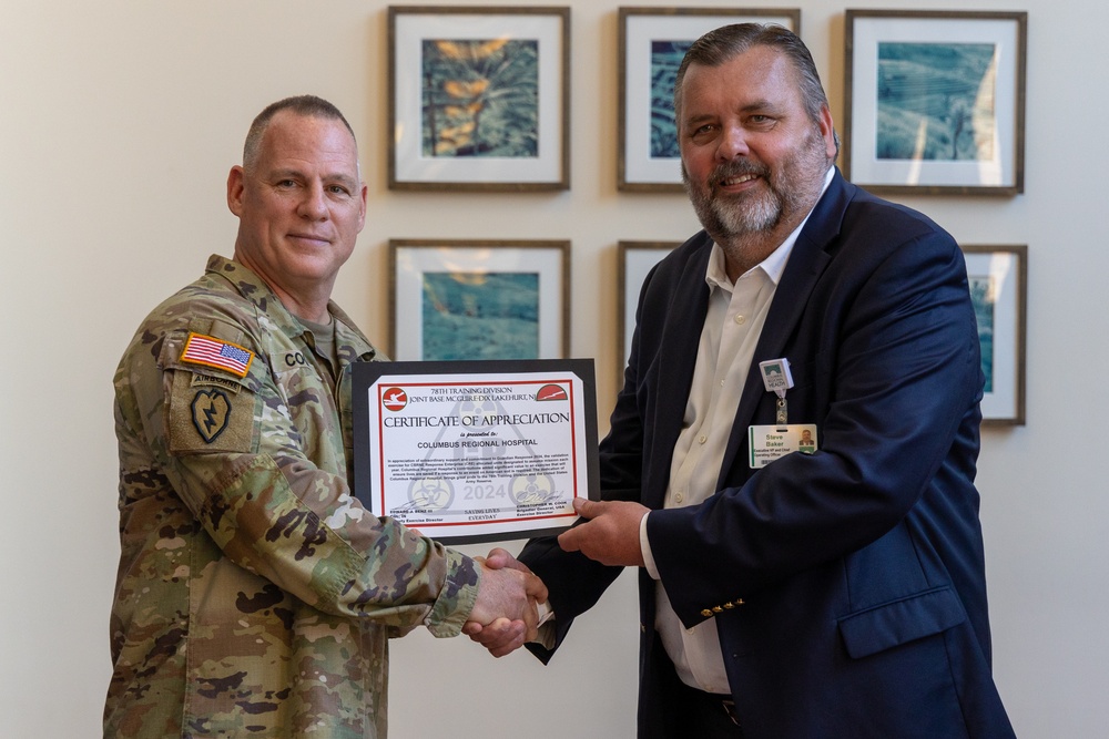 Brig. Gen. Christopher W. Cook presents a Certificate of Appreciation to Steve Baker