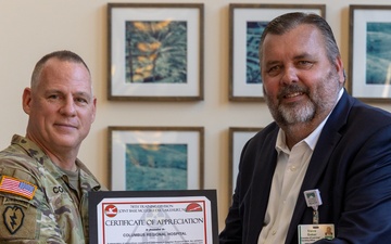 Brig. Gen. Christopher W. Cook presents a Certificate of Appreciation to Steve Baker
