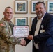 Brig. Gen. Christopher W. Cook presents a Certificate of Appreciation to Steve Baker