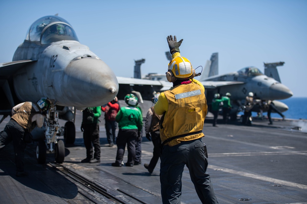 The &quot;Fighting Swordsmen&quot; of Strike Fighter Squadron (VFA) 32 Conduct an Airborne Change of Command Ceremony in the Red Sea