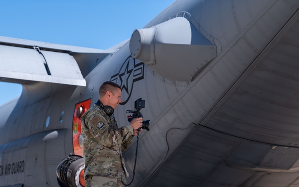 Master Sgt. Garrett Wake a public affairs specialist assigned to the 152nd Airlift Wing out of Reno, Nev. captures footage on the flightline at Channel Islands Air National Guard Station, Port Hueneme, Calif.