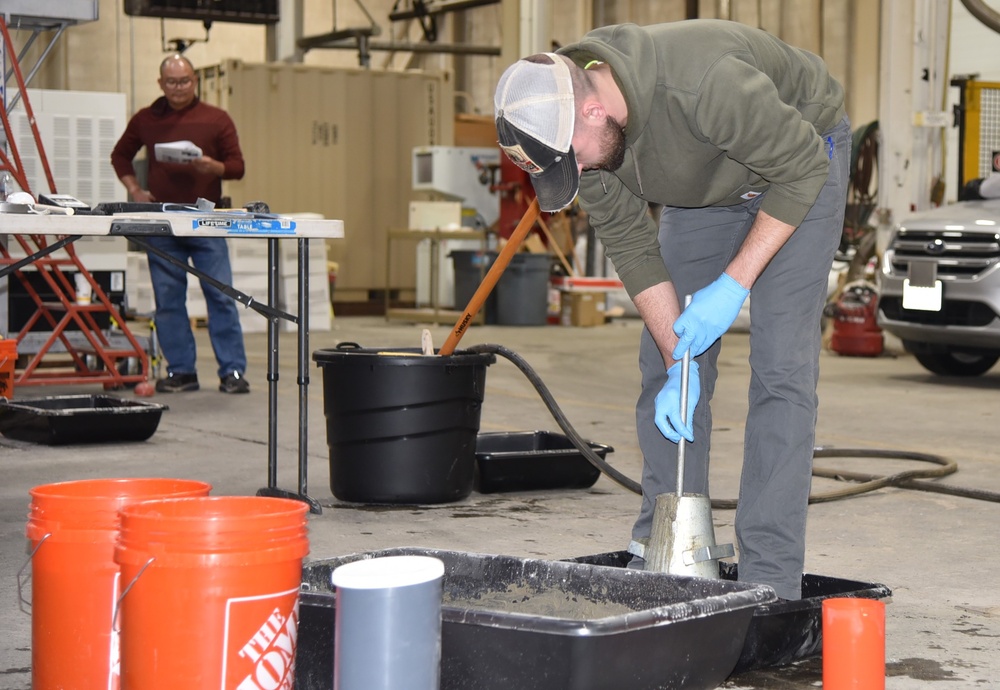 Adam Hartzheim, geotechnical engineer, performs a slump test during the ACI practical exam