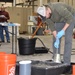 Adam Hartzheim, geotechnical engineer, performs a slump test during the ACI practical exam