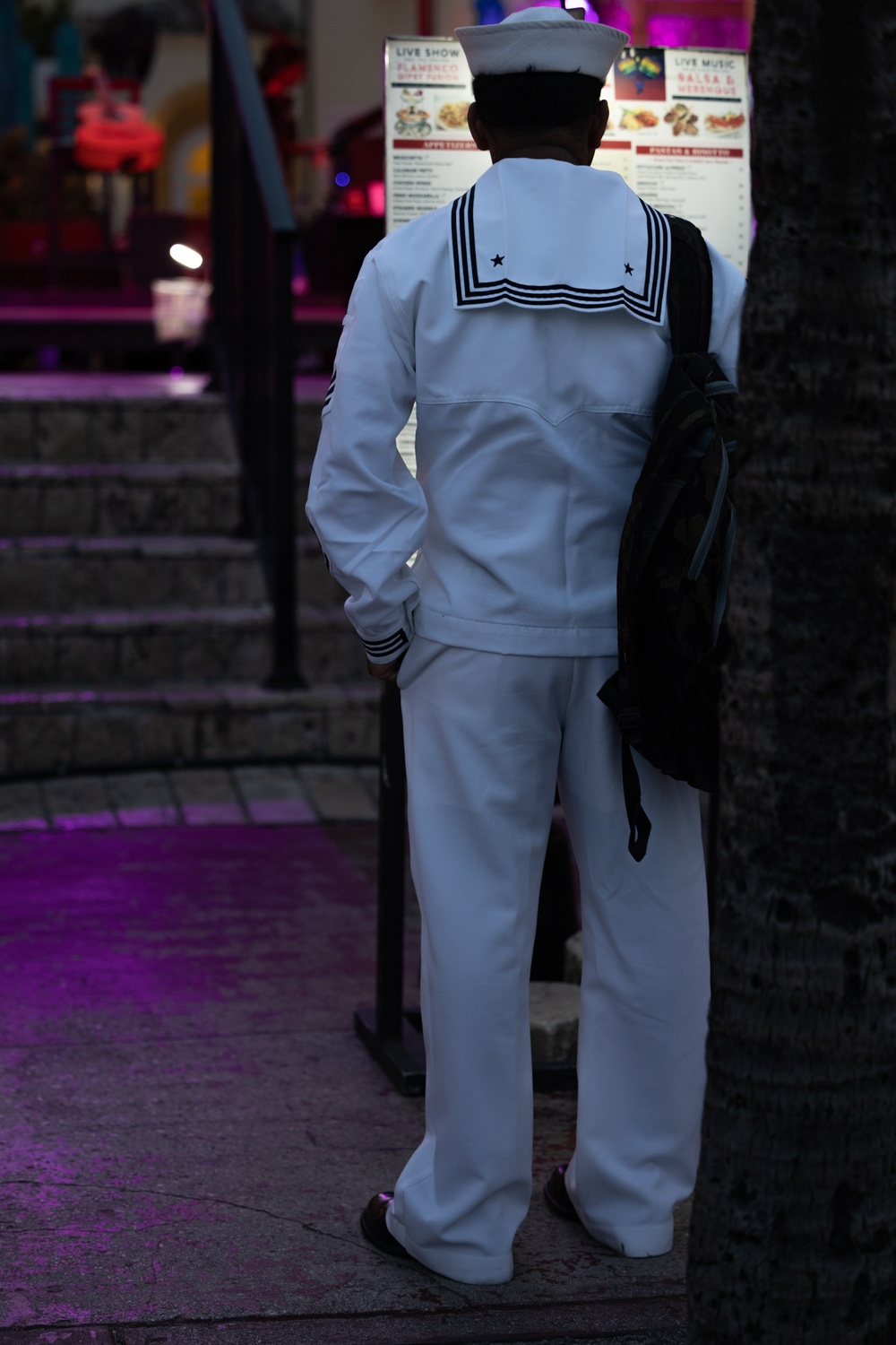 U.S. Navy Sailor reads a menu during Fleet Week Miami 2024