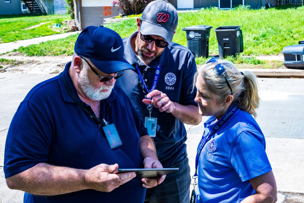 FEMA Officials Talks with a  FEMA Home Inspector