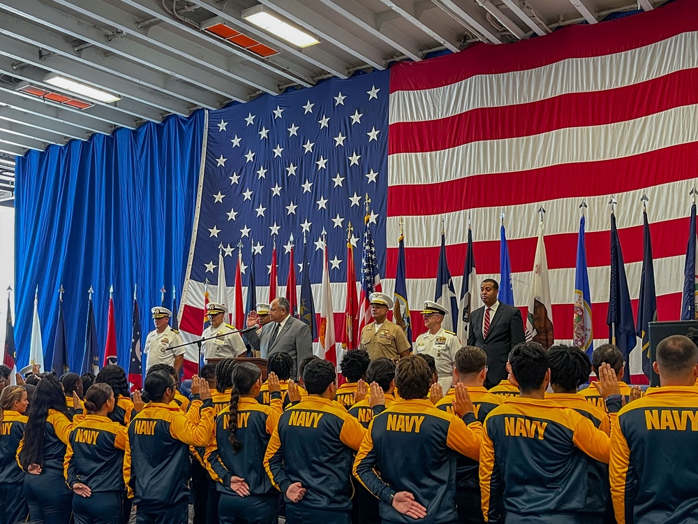 Secretary of the Navy Carlos Del Toro, center, and future U.S. Sailors and Marines recites the oath of enlistment during Fleet Week Miami 2024