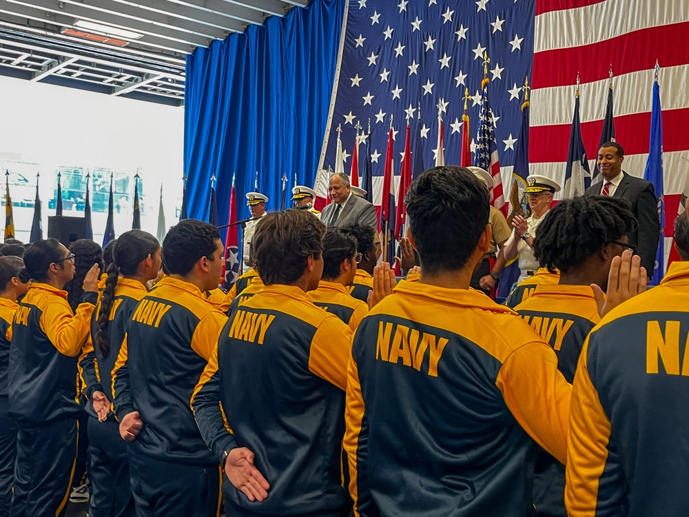 Secretary of the Navy Carlos Del Toro, center, and future U.S. Sailors and Marines recites the Oath of Enlistment during Fleet Week Miami 2024