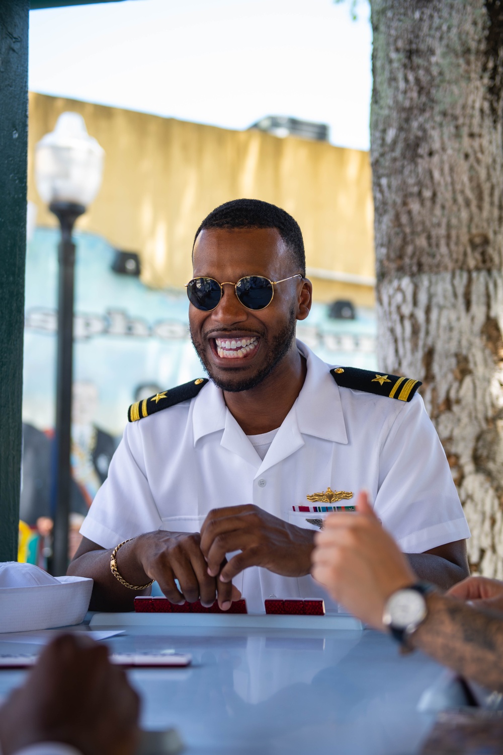 U.S. Navy Lt. j. g. Lavaujhn Holloman, from Norfolk, Va., assigned to the guided-missile cruiser USS Normandy (CG 60), plays dominoes in Domino Park, Miami, during Fleet Week Miami, May 8, 2024.