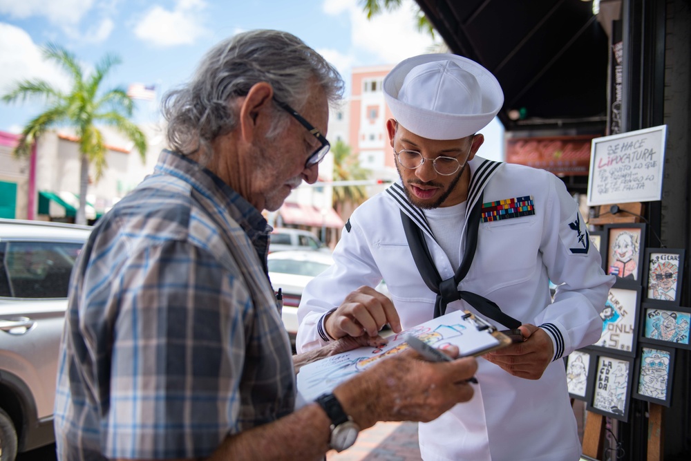 U.S. Navy Hospital Corpsman 3rd Class James Reddic, from St. Louis, assigned to the amphibious assault ship USS Bataan (LHD 5), looks at a portrait in Miami during Fleet Week Miami, May 8, 2024.