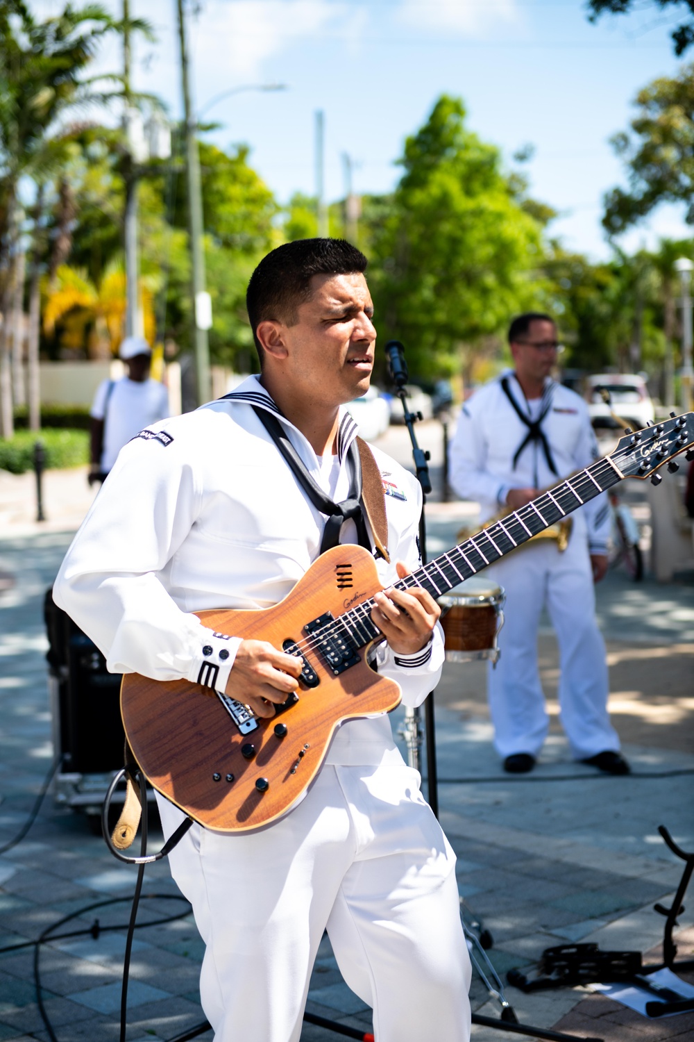 MIAMI - (May 8, 2024) U.S. Navy Musician 2nd Class Jorge Cabrera, from Los Angeles, assigned to Navy Band Southeast, plays the guitar during a public concert in Domino Park, Miami during Fleet Week Miami May 8, 2024.