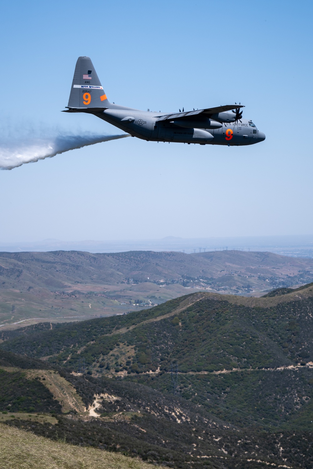 A C-130 (MAFFS 9) from Nevada Air National Guard's 152nd Airlift Wing performs a water drop May 8, 2024, during Modular Airborne Fire Fighting System (MAFFS) Spring Training