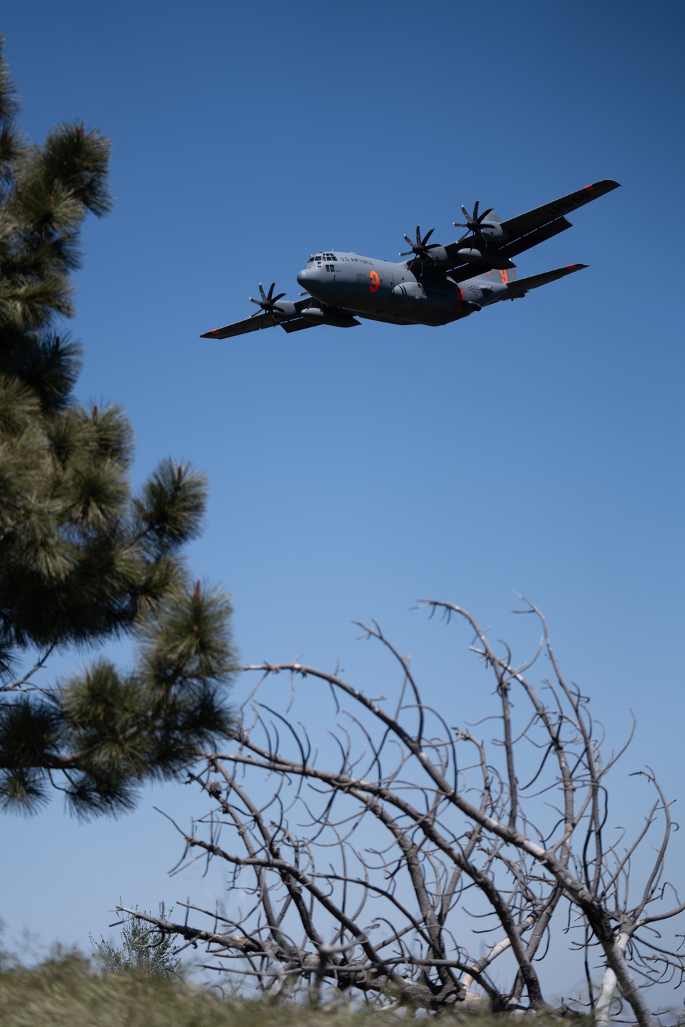 A C-130 (MAFFS 9) from Nevada Air National Guard's 152nd Airlift Wing does a dry pass before performing a water drop May 8, 2024, during Modular Airborne Fire Fighting System (MAFFS) Spring Training 2024