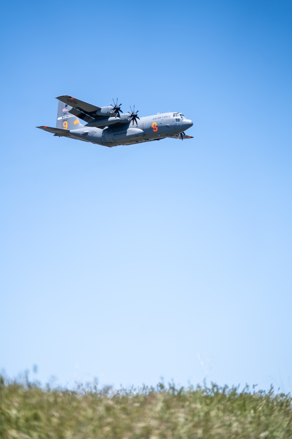 A C-130 (MAFFS 9) from Nevada Air National Guard's 152nd Airlift Wing does a dry pass before performing a water drop May 8, 2024, during Modular Airborne Fire Fighting System (MAFFS) Spring Training 2024