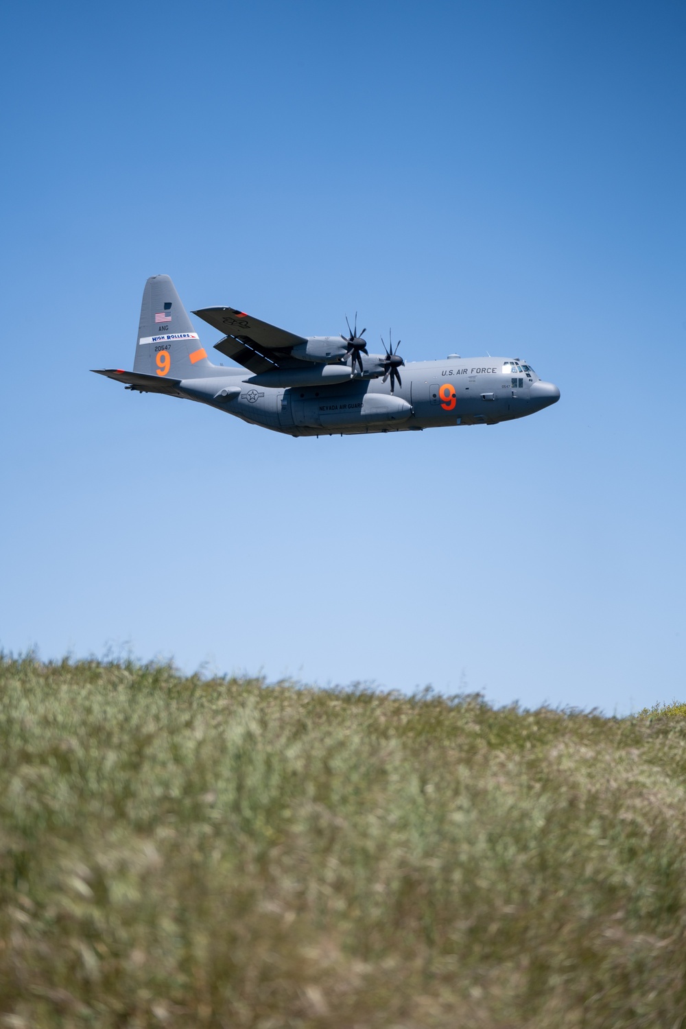 A C-130 (MAFFS 9) from Nevada Air National Guard's 152nd Airlift Wing does a dry pass before performing a water drop May 8, 2024, during Modular Airborne Fire Fighting System (MAFFS) Spring Training 2024