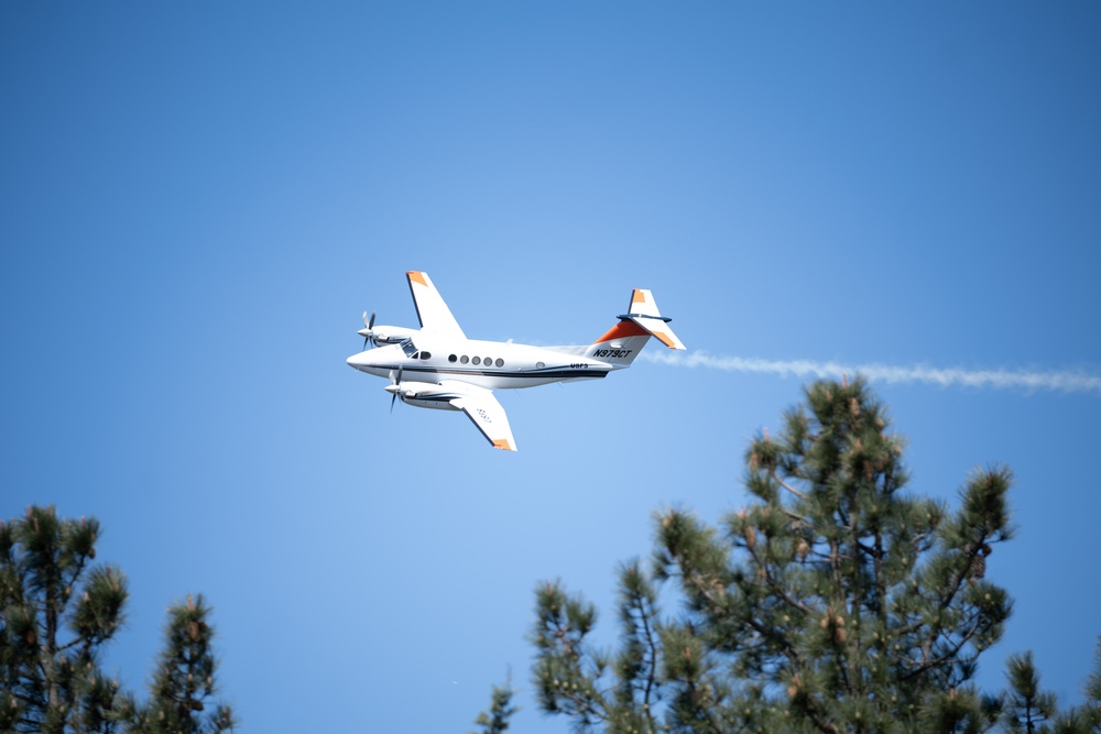 U.S. Forest Service Lead Aircraft dispenses a puff of smoke during Modular Airborne Fire Fighting System (MAFFS) Spring Training 2024