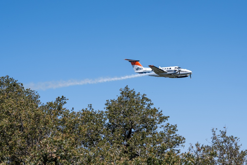 U.S. Forest Service Lead Aircraft dispenses a puff of smoke during Modular Airborne Fire Fighting System (MAFFS) Spring Training 2024