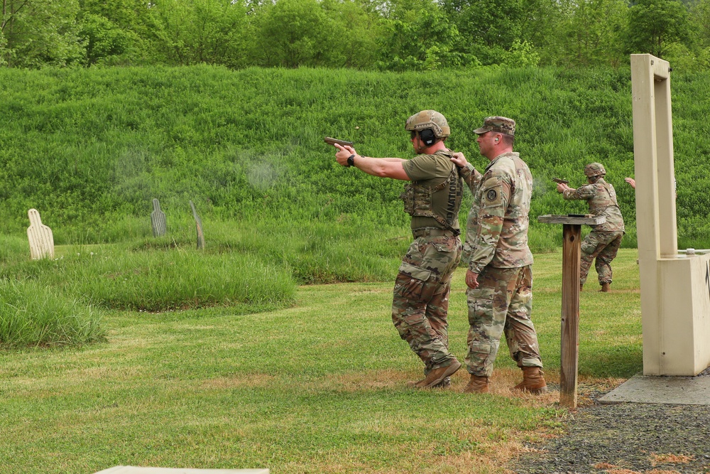 Competitors Fire Pistols during Combat Pistol Qualification Course