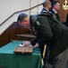 A Soldier from the U.S. Army John F. Kennedy Special Warfare Center and School signs a regimental logbook during a  Graduation Ceremony