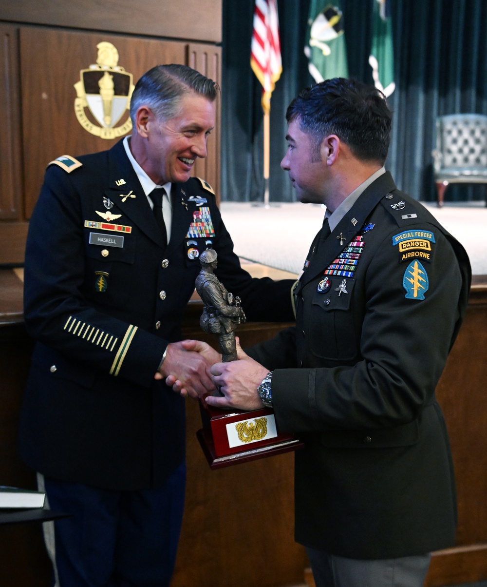 Colonel David J. Haskell presents the Distinguished Honor Graduate award to a student