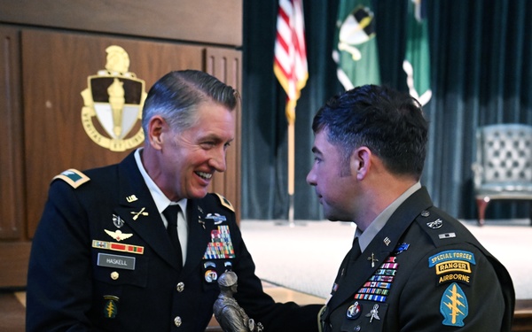 Colonel David J. Haskell presents the Distinguished Honor Graduate award to a student