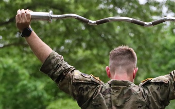 Maryland Army National Guard Soldier using an EZ Bar for a Static Hold during the Region II Best Warrior Competition