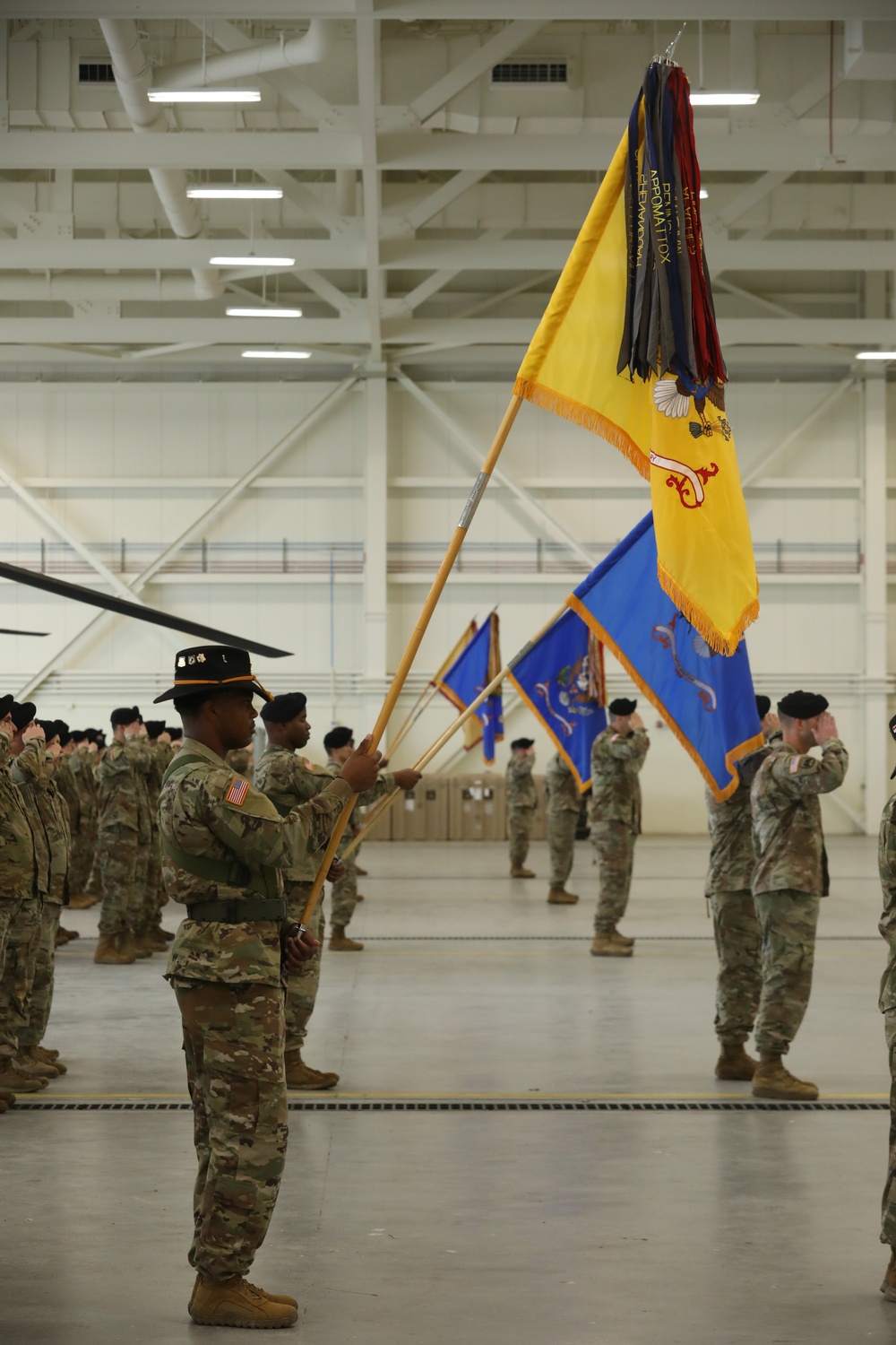 Soldiers present arms during the colors casing ceremony