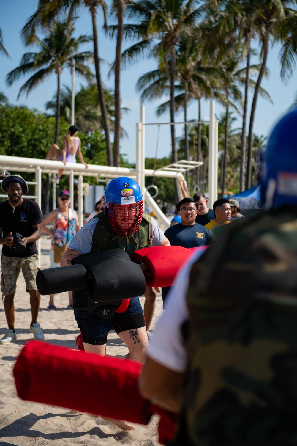 U.S. Coast Guard members competes in a pugil stick fight during the “Top Gun” Beach Olympics event in Miami Beach, Fla., during Fleet Week Miami, May 11, 2024.