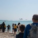 U.S. Maritime service members and civilians observe a helo-drop during the “Top Gun” Beach Olympics event in Miami Beach, Fla., during Fleet Week Miami, May 11, 2024.